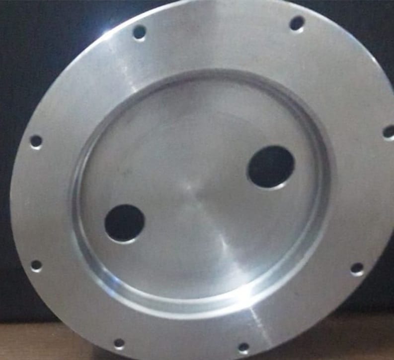 High-precision CNC turning machine producing cylindrical shafts and bushings for industrial machinery