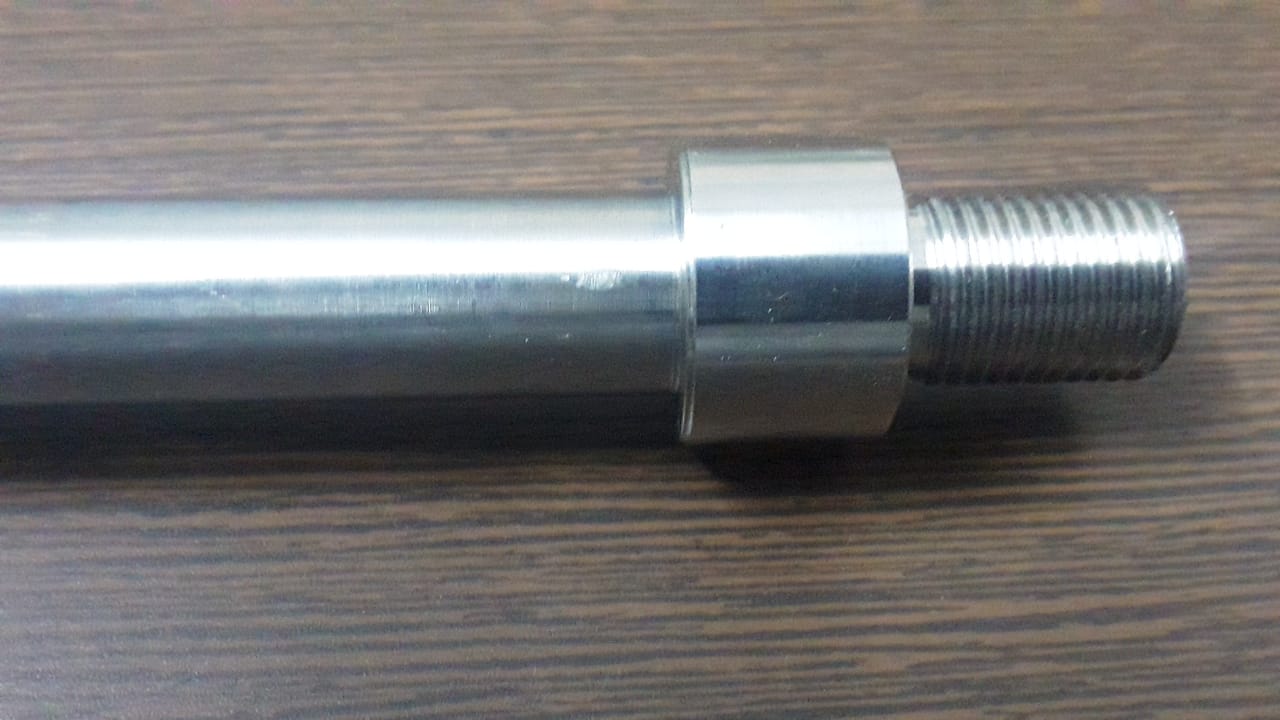 CNC lathe machine producing threaded components and precision shafts